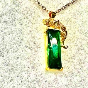 Gold pendant emerald with necklace.